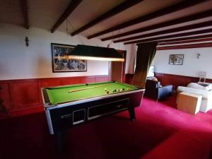 a living room with a pool table in a room at Scorrabrae Orphir Mainland Orkney South Shore Retreat in Orphir