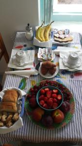 a table topped with a plate of fruit and bread at Albatros in Symi