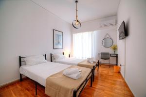 Posteľ alebo postele v izbe v ubytovaní L'appartement blanc dans le centre de Glyfada
