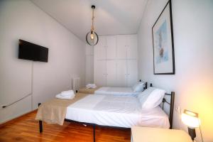 Posteľ alebo postele v izbe v ubytovaní L'appartement blanc dans le centre de Glyfada