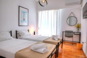 Posteľ alebo postele v izbe v ubytovaní L'appartement blanc dans le centre de Glyfada