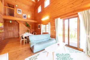 a living room with a couch and a table at Keiko's Home Beautiful Resort Villa 20 min to Tenjin free park in Itoshima