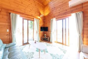 a living room with a couch and a table at Keiko's Home Beautiful Resort Villa 20 min to Tenjin free park in Itoshima