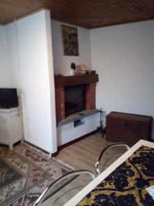 a living room with a fireplace in the corner at Casa Vacanza PIZZO CAMINO in Calasca Castiglione