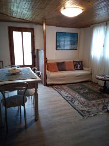 a living room with a couch and a table at Casa Vacanza PIZZO CAMINO in Calasca Castiglione