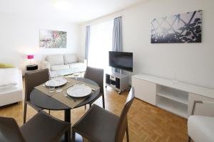 a living room with a table and chairs in a room at CITY STAY - Kirchweg in Zurich