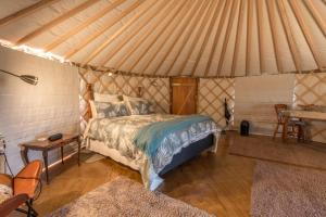 a bedroom with a bed in a tent at The Yurt Wai Rua in Whangarei