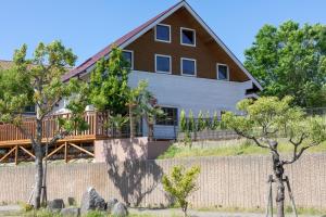 a large house with a fence and trees at Keiko's Home Beautiful Resort Villa 20 min to Tenjin free park in Itoshima