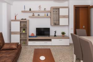 A television and/or entertainment centre at AGUAMARINA C, 11-51