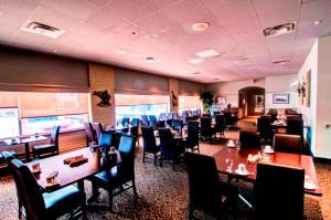 a dining room filled with tables and chairs at Wescana Inn in The Pas