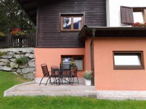 a patio with chairs and a table in front of a house at Haus Julia in Bad Kleinkirchheim