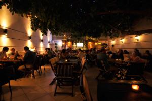 a group of people sitting at tables in a restaurant at night at Ak Efe Hotel EDİRNE in Edirne