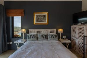 a bedroom with a large bed and a television at Nature's Cottage in Kenton on Sea