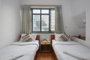 Letto o letti in una camera di Pacific Guest House