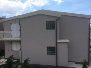 a white building with a cross on top of it at Apartment Cesarica in Cesarica +37 photos