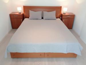a bedroom with a large bed with two night stands at Apartment Cesarica in Cesarica +37 photos