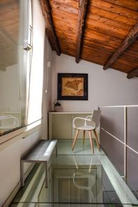 a chair sitting in a room with a glass floor at Rooms 19 B&B in Palermo
