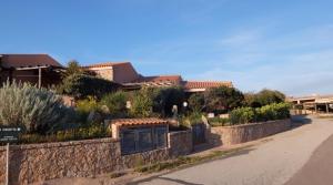 a stone wall with a gate in front of a house at Villino Saccu in Costa Paradiso