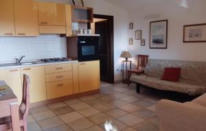 a living room with a couch and a kitchen at Villino Saccu in Costa Paradiso