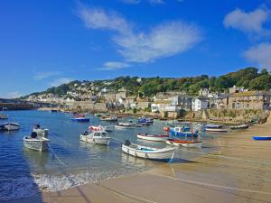 a bunch of boats are docked in the water at Calac Cottage in Mousehole
