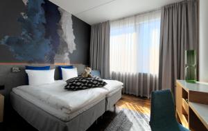 Postel nebo postele na pokoji v ubytování GLO Hotel Sello