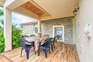 a patio with a table and chairs on a deck at Haus Glavani in Barban