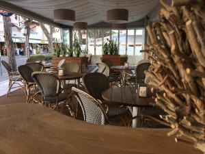a row of tables and chairs in a restaurant at Hotel Arena in Lido di Jesolo