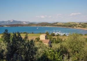 a view of a lake with a boat in the water at Torre di Baratti Bio Resort in Populonia