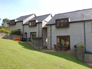 a house with a lawn in front of it at Pine Cottage in Falmouth