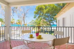 a table on a balcony with a view of the ocean at Garballons 5 1D in Port d'Alcudia