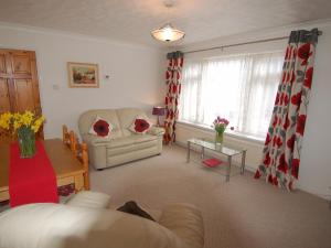 a living room with a couch and a table at Trevillas in St Austell