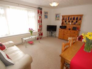 a living room with a couch and a table at Trevillas in St Austell