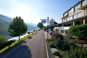 an empty street next to a building next to a lake at Sonnenuhr in Bernkastel-Kues