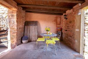 a patio with a table and chairs in a building at Valterra y Tosal in Torres-Torres