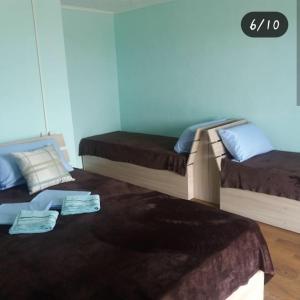 two beds sitting on the floor in a room at Отдых на Балхаше in Balqash