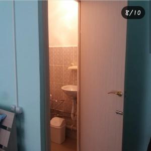 an open door to a bathroom with a sink and a toilet at Отдых на Балхаше in Balqash