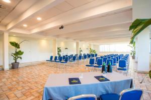 a banquet hall with blue tables and chairs at Hotel Isola Sacra Rome Airport in Fiumicino