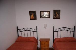 Postel nebo postele na pokoji v ubytování Hostal Alcázar