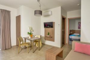 a living room with a table and a couch at Blue Horizon Apartments in Balíon