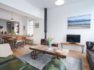a living room with a couch and a table at Gwalia Stores in Beaumaris