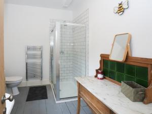 a bathroom with a glass shower and a toilet at Gwalia Stores in Beaumaris +15 photos
