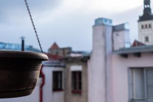 a pot hanging from a chain in front of a building at Dream Stay - Five Bedroom Penthouse in Old Town in Tallinn