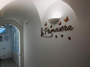 a sign on a wall with butterflies on it at La Primavera in Anacapri