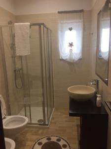 a bathroom with a shower and a sink and a toilet at La casa nel verde in Castelmezzano