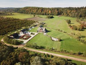 an aerial view of a large house on a green field at W dolinie Sanu in Lesko