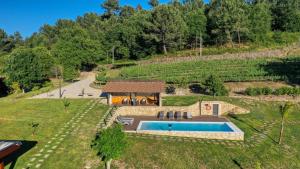 an overhead view of a villa with a swimming pool and a house at Quinta de Silharezes, Lda in Ponte da Barca