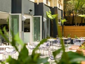 a group of tables and chairs on a patio at Hotel Urban St Leonards in Sydney