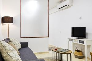 ein Wohnzimmer mit einem Sofa und einem TV in der Unterkunft LEEWAYS LOFT V in GRAN VÍA in Madrid