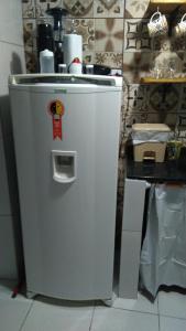 a white refrigerator in a kitchen with a counter at O Pouso Sobrado in Mucugê