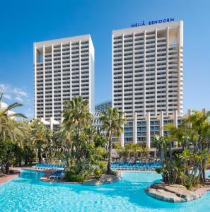 
a large pool of water with palm trees at Melia Benidorm in Benidorm
